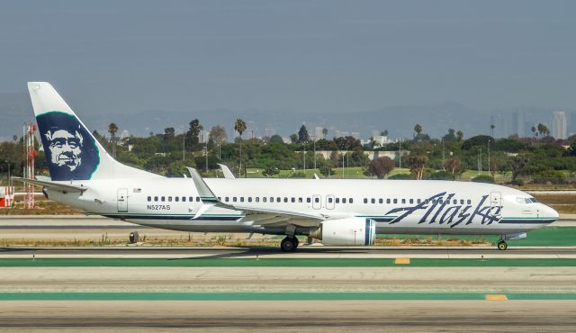 Boeing 737-800 (N527AS) - ASA475 heads out to runway 24L bound for Seattle-Tacoma. Taken through terminal glass.