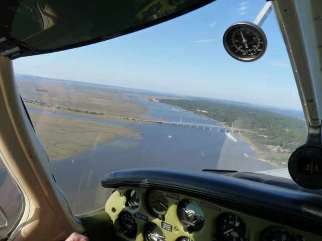 Piper Cherokee (N7894C) - Turning final for Rwy 36 to cross the M.E. Thompson bridge at Jekyll Island, Georgia, about to experience the famous Jekyll "Burble." This force of nature tries to grab your aircraft and throw it into the marsh as you drop below tree-top level.  The sea breeze cross winds definitely get your attention.  