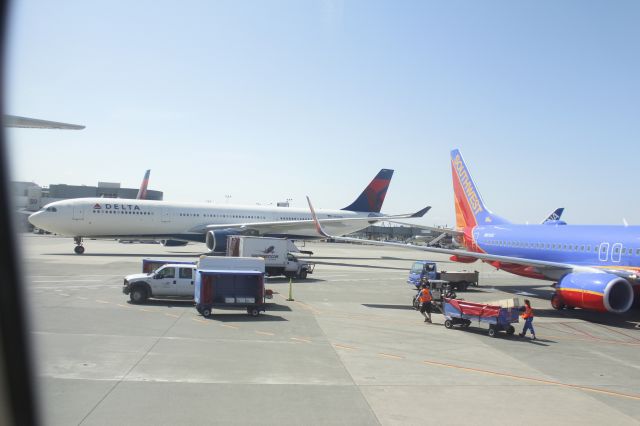 Airbus A330-300 (N812NW) - 050714 Delta taxiing in to south side past SWA B737 N8310C