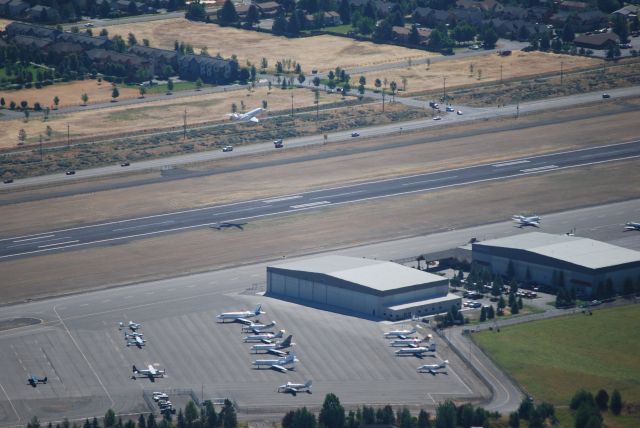 — — - Plane departing southbound with the Atlantic Aviation in the foreground at the Friedman Memorial airport