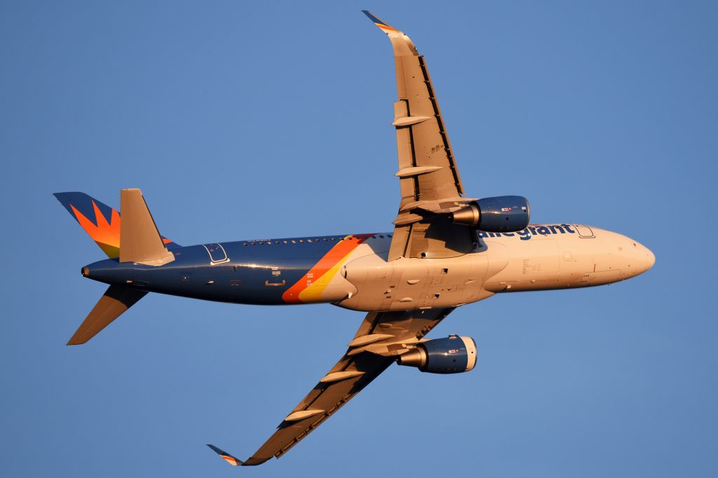 Airbus A320 (N249NV) - Clean belly in the golden rays of the sun late in the day.