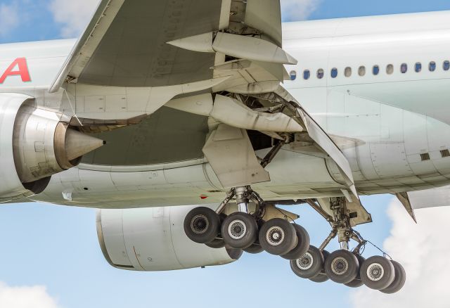 BOEING 777-300ER (C-FIVS) - Close up of some equipment on this AC 777 as she crosses Airport Road, over the fence and down to runway 23 at YYZ. Some curious folks looking out their windows putting the size of this airliner into perspective!