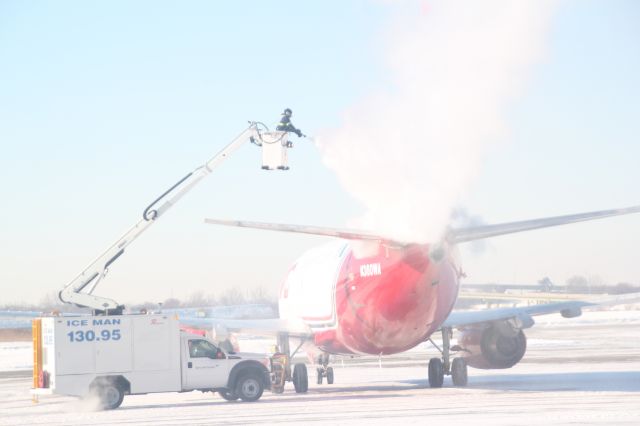 Rockwell Turbo Commander 690 (N360WA) - Northern Air Cargo 737 getting de-iced before takeoff on the deicing pad at Gary Regional Airport.  Photo taken 2/7/2014.