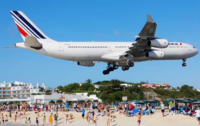 — — - The second biggest heavy at TNCM about to touchdown. Taken from sunset bar at Maho beach St. Maarten.