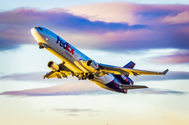 Boeing MD-11 (N621FE) - FedEx MD11 taking off from PHX on 11/9/22. Taken with a Canon R7 and Tamron 70-200 G2 lens. I absolutely adore the colors in this photo, and I think that the purple clouds from the sunrise work wonderfully with the FedEx livery!