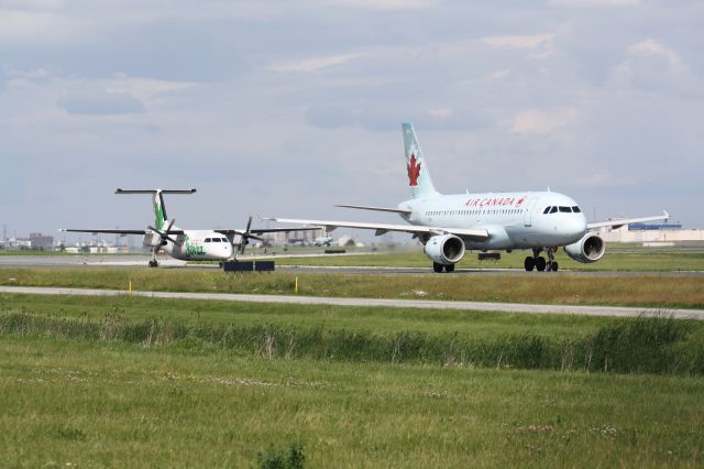 — — - Typical Sunday Afternoon At Lester B. Pearson Intl Airport,CYYZ/YYZ Air Canada jazz following his sister Air Canada down the taxiway.