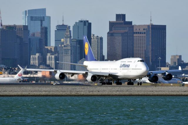 Boeing 747-400 (D-AVBS) - Lufthansa 9922 Heavy taxis out for the last time with the Boston skyline In the Background heading to the  Mojave   Desert For storage 