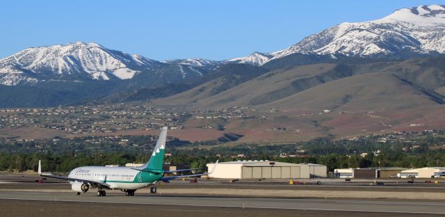 Boeing 737-800 (N916NN) - Not long ago, I received an email asking if I knew what the design on the tail of Americans "Reno Air" heritage livery scheme was representing.  The writer knew that the city of Reno is located "near Lake Tahoe," but wanted to know if the mountains on the tail of N916NN actually depict any real scene.  As shown in this photo, the answer is "yes."br /AALs "Reno Air" heritage livery B738 is captured here at 6:30 AM on its takeoff roll along Reno Tahoe Internationals 16L.  From this spotting location, as N916NN races down 16L, two of the mountains depicted on the tail are visible in the background:  Slide Mountain on the left and Mt. Rose on the right.  