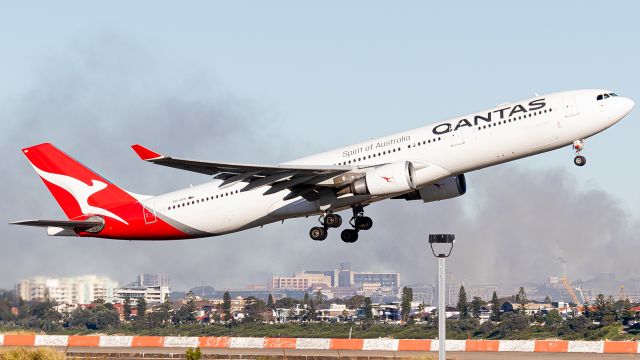 Airbus A330-300 (VH-QPH) - VH-QPH jetting out of Sydney YSSY on runway 34L with a factory being extinguished to the right. 