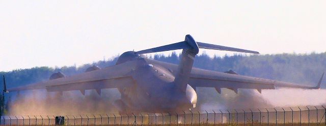 — — - C-17 climbing out.