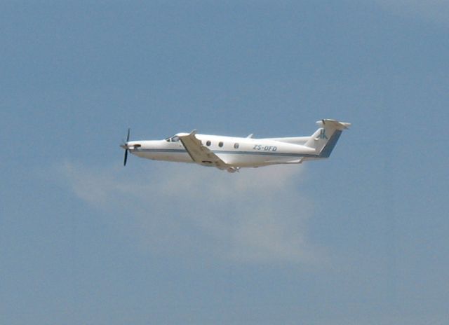 Pilatus PC-12 (ZS-OFD) - Departure at Lanseria en route to Namibia.