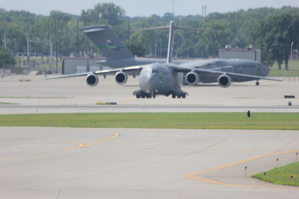 Boeing Globemaster III (N66165) - USAF C-17 Globemaster III departing light at Indy. Her sister ship in the background