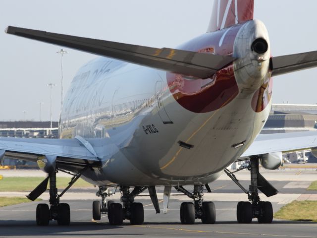 Boeing 747-200 — - Not the most flattering angle, but an interesting view. Note the 2 open outlfow valves at the lower rear of the aircraft fuselage.