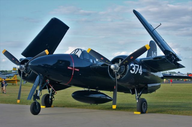 — — - Setting Oshkosh Sun on the Grumman F-7F Tigercat.