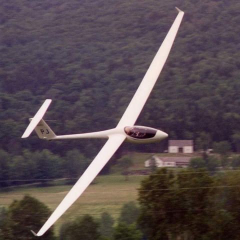 N24PJ — - HIgh-speed pass at ~140 knots for a visiting photographer at the 1994 U.S. National Soaring Championships, Sugarbush, VT. Background is a valley. Photographer is standing next to the runway. Right wingtip is below the camera lens. Pilot/owner Peter Jacobson.