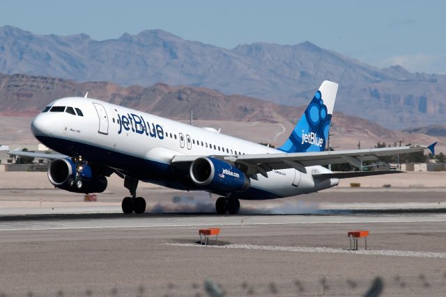 Airbus A320 (N655JB) - The airline's 100th Airbus, "Blue 100", touching down on runway 25L.