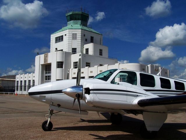 Beechcraft Baron (58) (N501CE) - Parked in front of the 1940 Air Terminal Museum.