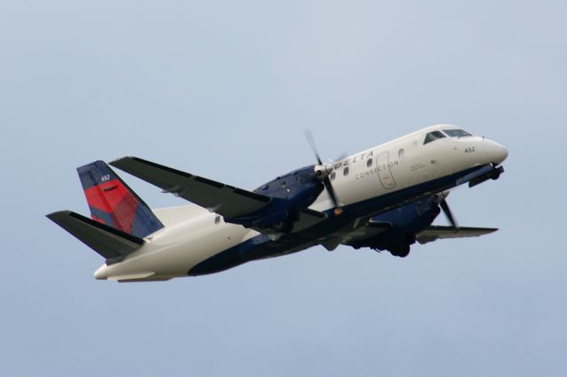 Saab 340 (N452XJ) - A Mesaba Saab 340 painted in the new Delta colors climbs out of KFSM.