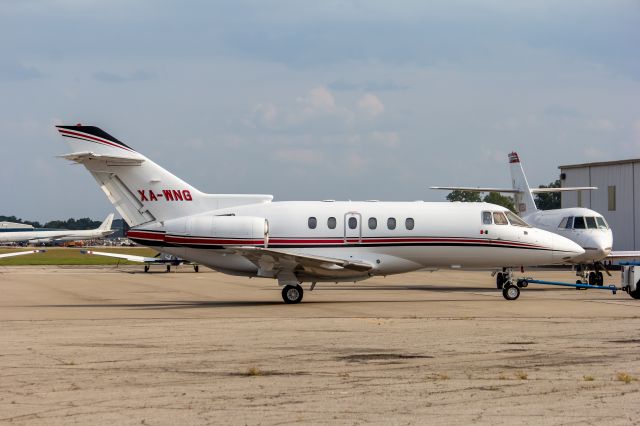 Hawker 800 (XA-WNG) - Private Hawker 800XP being tugged into the hangar. The FA20 in the background was involved in a fatal accident about a year ago delivering auto parts to HQU