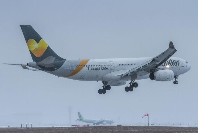 Airbus A330-200 (C-GTSZ) - Operating as TS287 from Rome, this Transat bird in full Condor/ThomasCook colours. Here on very short finals for runway 06R while an AC E190 throttles up to take off from 06L