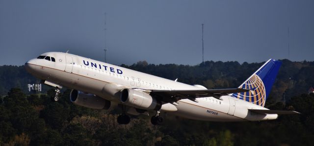 Airbus A320 (N476UA) - Beautiful rotation in the early morn off of 23R, from the top of the RDU parking deck, 4/14/18.