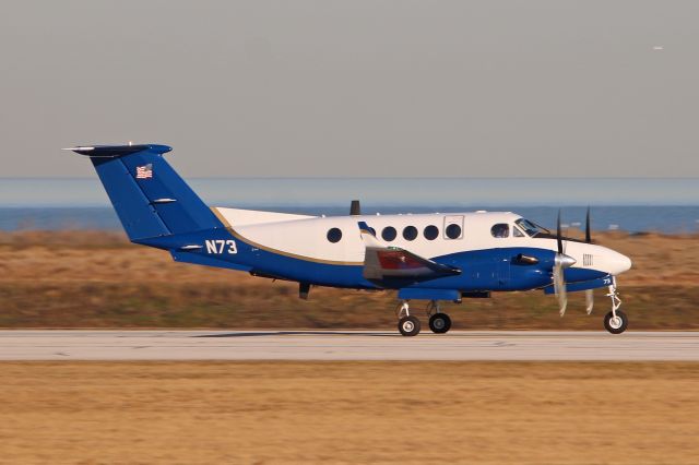 Beechcraft Super King Air 300 (N73) - Flight Check 73 during an early morning departure on RWY 6L amidst a scenic Cleveland/Lake Erie backdrop on 27 Mar 2019.