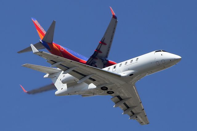 Bombardier Challenger 300 (N541XJ) - Private Bombardier Challenger 300 takes off from Van Nuys Airport while a SouthWest Boeing 737 descends to land to Bob Hope airport right above. Taken in Van Nuys, California.  