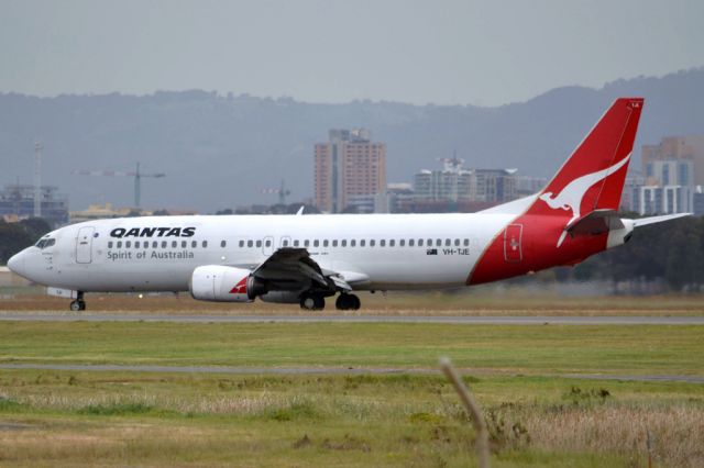 BOEING 737-400 (VH-TJE) - On taxi-way heading for Terminal 1 after landing on runway 23. Friday 5th October 2012.