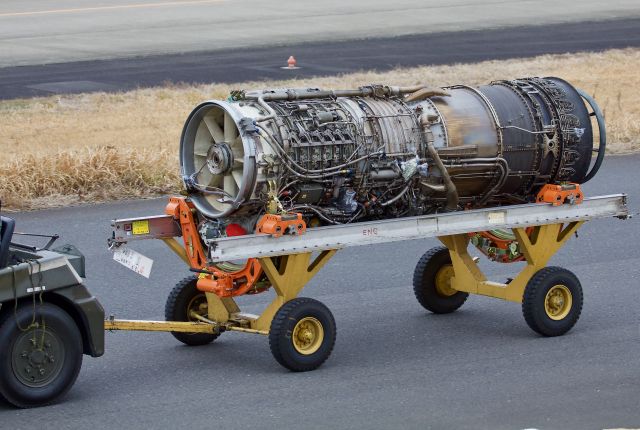 — — - A J79, the engine that powers the mighty F-4 Phantom (amongst other aircraft), being towed to the engine shop at Hyakuri for work (please view in "full' for highest image quality)