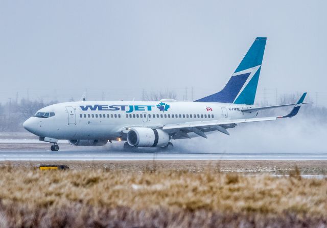 Boeing 737-700 (C-FMWJ) - Westjet 821 arrives from Halifax and splashes down on an ice covered runway 05. Braking action was reported poor by all types today.br /April 14th, 2018