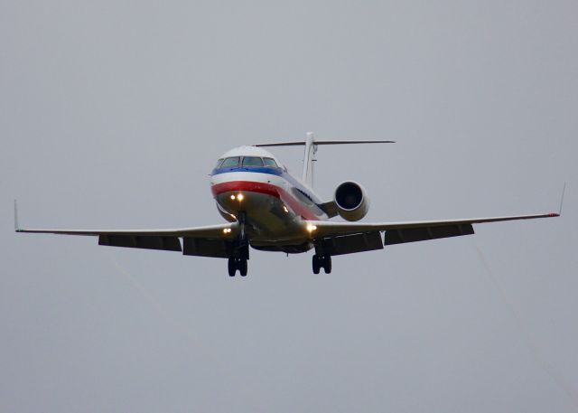 Canadair Regional Jet CRJ-200 (N879AS) - At Shreveport Regional. Landing in the rain.