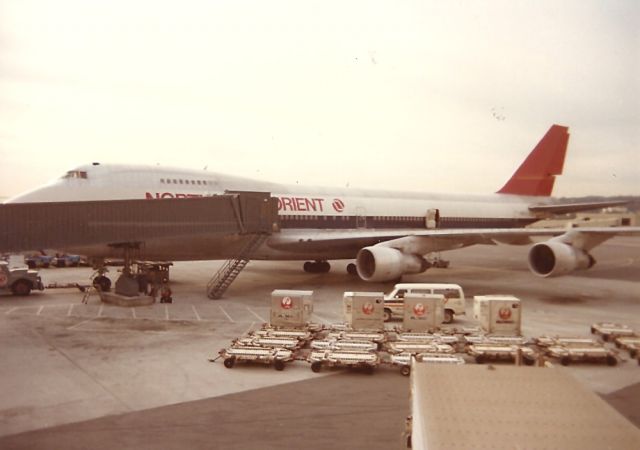 Boeing 747-200 (N621US) - early 1980 photo at the old International dock- This camera shy 747-200(cn19919/81) in Northwest Orient colors is readied for a flight to Tokyo.
