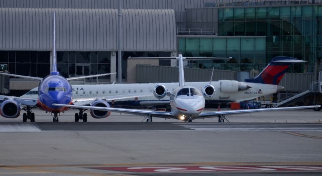 Cessna Citation CJ1 (N525CD) - There was quite a bit going on when I snapped this one, N525CB turning onto runway 20R for takeoff, the Southwest is holding short of runway 20L for a landing GA aircraft and the Skywest CRJ-900 taxing on "Alpha" to the regional terminal.