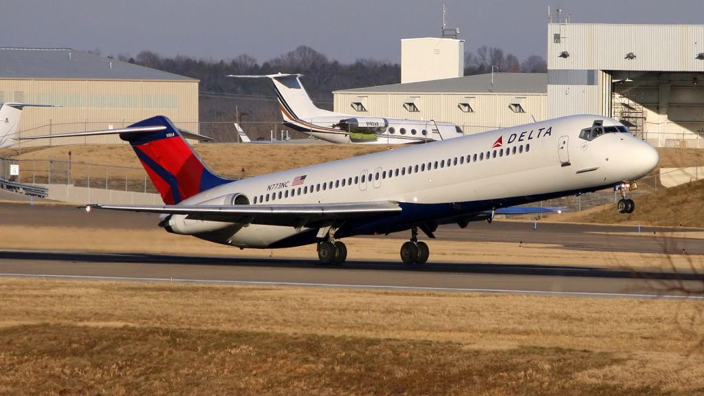 McDonnell Douglas DC-9-50 (N773NC) - Delta DC-9-51 rotates on runway 20 center at Nashville. A Gulfstream undergoing maintenance is parked in the background.