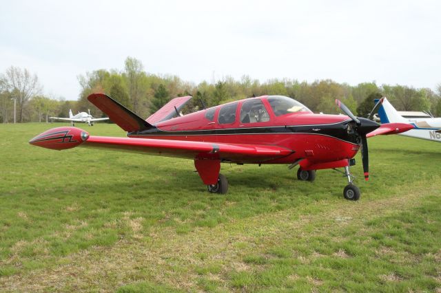 Beechcraft 35 Bonanza (N12711) - Pretty red Bonanza (along with a few other Bonanzas, Skippers, and Musketeers) at the Beechcraft Heritage Museums BHM Board of Trustees Meeting 2008.