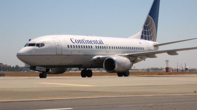 Boeing 737-700 (N16703) - Holding short of RWY 19R