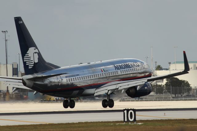 Boeing 737-700 (XA-CAM) - Aeromexico flight 422 from Lic. Benito Juarez Intl on final for RWY 9. Taken from just east of El Dorado Furniture. 3/31/13