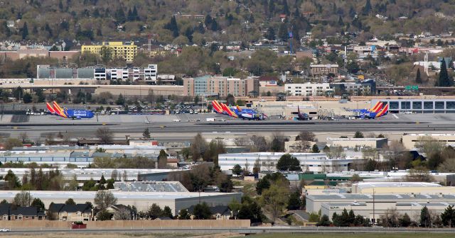 Boeing 737-700 (N280WN) - Taken from the ground and 4.3 miles directly east of RNO, this shot shows Concourse B and a portion of the alley between B and C at Reno Tahoe International. Normally, Concourse B is used at various times of the day by Southwest, Delta, Frontier, and jetBlue. However, in this shot, nine of the eleven gates are occupied by Southwest aircraft. The three SWA birds on the far left are being stored at the edge of the Southwest apron. That totals an even one dozen Southwest aircraft; the most SW fleetbirds ever seen at RNO at the same time.br /NOTE: "Missouri One" (N280WN) is visible in the center of the photo at Gate B9. Also, there is a Southwest jet at Gate B11 but it is difficult to see at this distance because it is parked "tail on" to my location 4+ miles away.