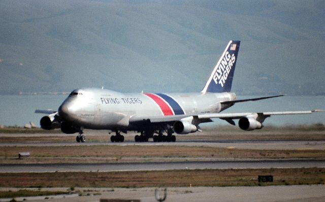 BOEING 747-100 (N8XXFT) - KSFO- Flying Tiger 747 N8xxFT rolling 28R for HKG or ANC in this photo, possibly taken summer 1984 from the old SFO observation deck ( now closed..)