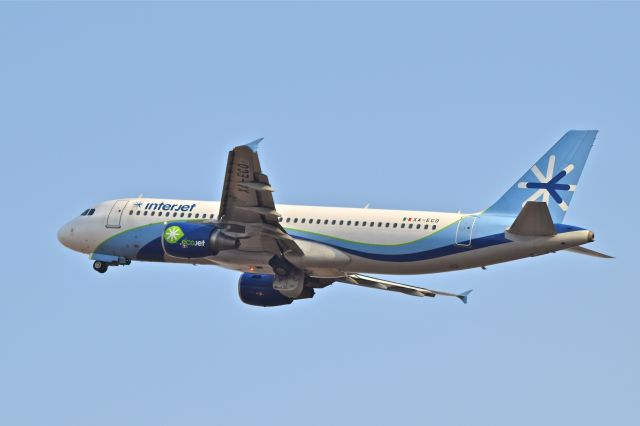 Airbus A320 (XA-ECO) - A320-214, airframe 4733 with sticker "EcoJet" biofuel promotion, on departure from 05L runway in Mexico International Airport. At the present stored.