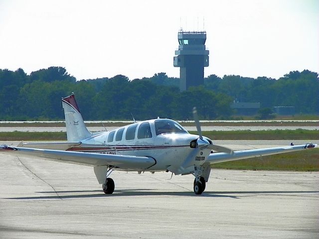 Beechcraft Bonanza (36) (N524CN) - Taxiing to the FBO at Brunswick Executive AIrport with abandoned Navy control tower in background. (Formerly Brunswick NAS-KNHZ)