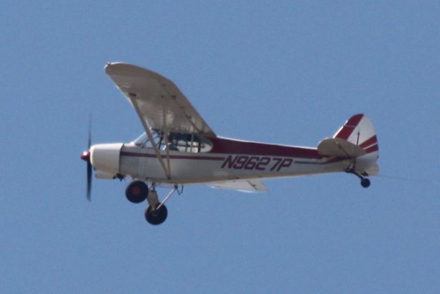 Piper L-21 Super Cub (N9627P) - Overhead at the NHRA race at Gateway Motorsports Park 2013, dragging a huge sign, either for AAA or Geico