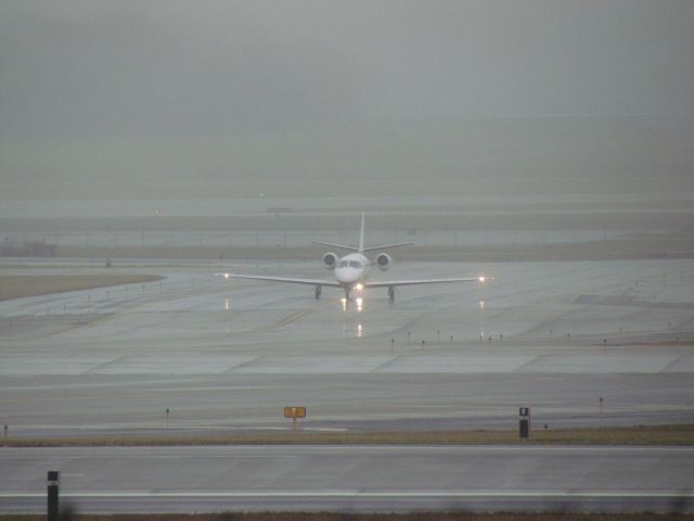 Cessna Citation Excel/XLS (N70TH) - A Cessna Citation Excel taxing on a wet taxiway at CVG