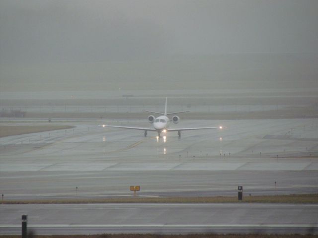 Cessna Citation Excel/XLS (N70TH) - A Cessna Citation Excel taxing on a wet taxiway at CVG