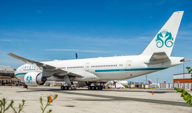 Boeing 777-200 (P4-XTL) - The worst parking spot imaginable for photographs but we make do! This aircraft brought the Boston Red Sox to Toronto for a series against the Toronto Blue Jays after their stint in London, England against the Yankees, a 50 run extravaganza!!