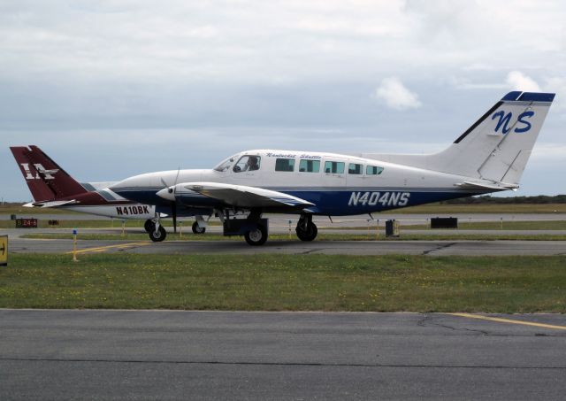 Cessna 402 (N404NS) - All companies are busy on a summer Sunday at Natucket.