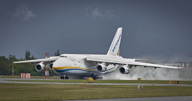 Antonov An-12 (UR-82008) - Antonov An-124 Ruslan landing on wet runway at Poznan Airport  (EPPO)