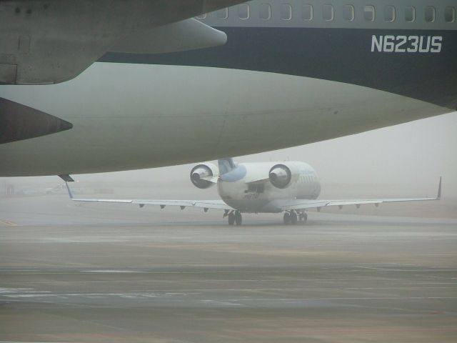 Canadair Regional Jet CRJ-200 — - taxiing out behind a 747