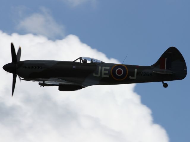 — — - The Griffin powered Supermarine Spitfire silouetted against a cloud.