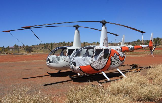 Robinson R-44 (VH-TWW) - If you are going to do heli tours of the Rock then jazz up the Robbo in Indigenous Art like this one at YARE seen recently